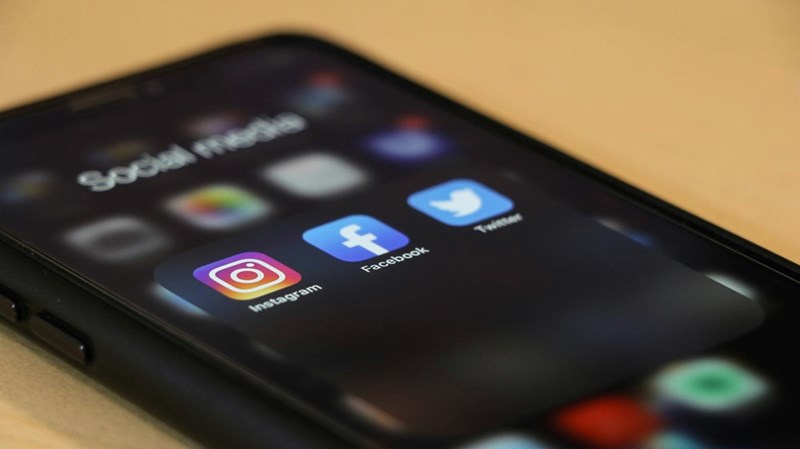 Model image of a phone with social media apps installed in it.