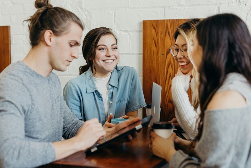 A group of students studying together in a coffee shop.