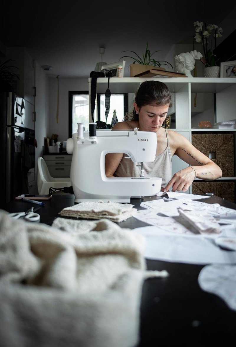 A 28-year-old mother sews dresses for her daughter to wear every day, even though her daughter is sometimes hesitant to wear them because of her shy nature. 
