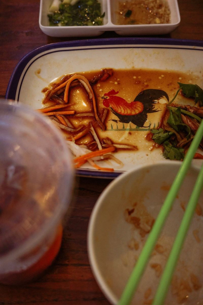 dirty plate with leftover food and chopsticks