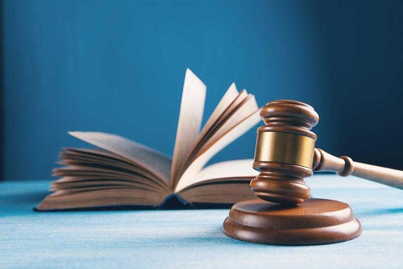 A book open with a judge's gavel beside it, visual representation.