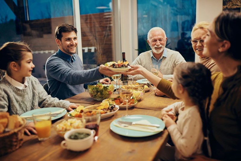 A family gathers for dinner, discussing in detail their son's appearance compared to his wife's, whom they find more attractive. 