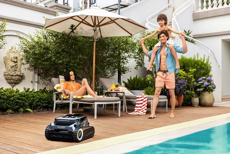 Family relaxing beside a backyard swimming pool during warm weather, representing a heatwave gathering hosted for relatives and friends.