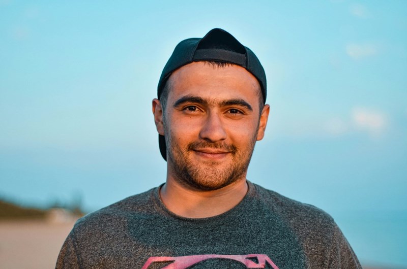 Young renter standing outdoors, representing a tenant navigating housing concerns, lease issues, and security deposit disputes.