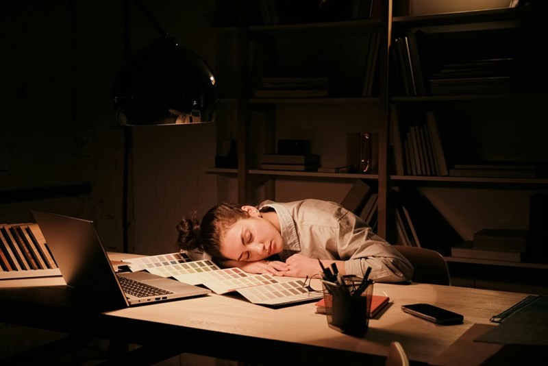 Exhausted worker faces burnout after managing an overwhelming workload and long hours on the job.