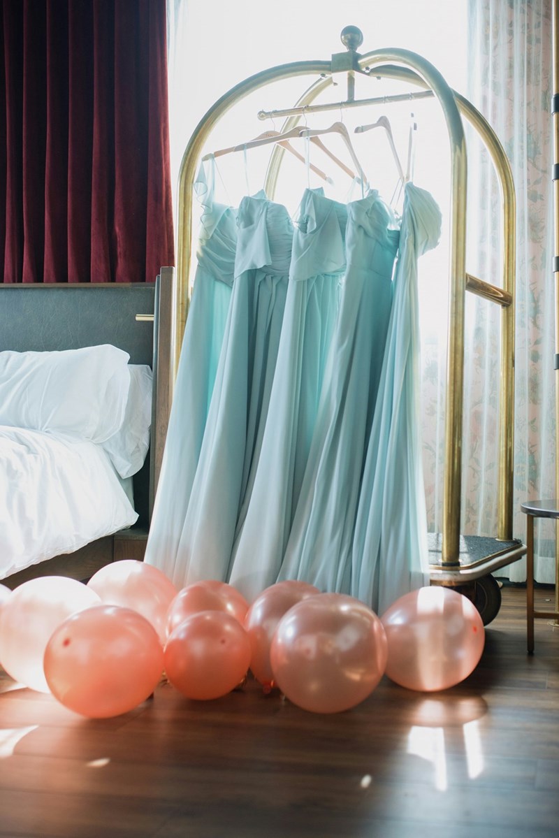 A rack of bridesmaid dresses, ready for a wedding. 