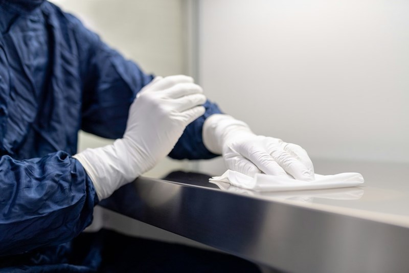 a person drying a surface with a paper towel