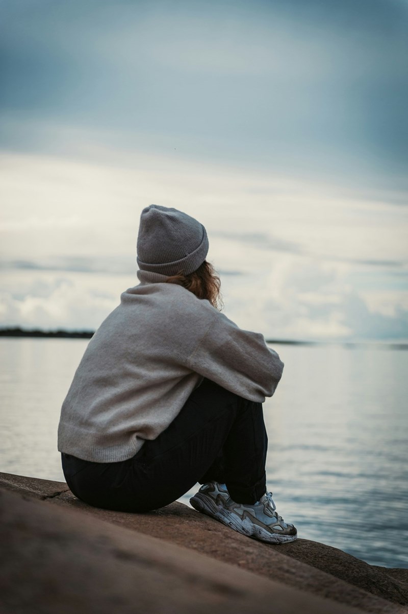 person in gray hoodie looking at the horizon
