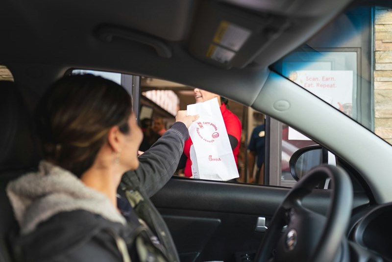 Woman seated inside a vehicle during a fast-food stop, representing the couple’s repeated drive-thru routine and order-checking system.