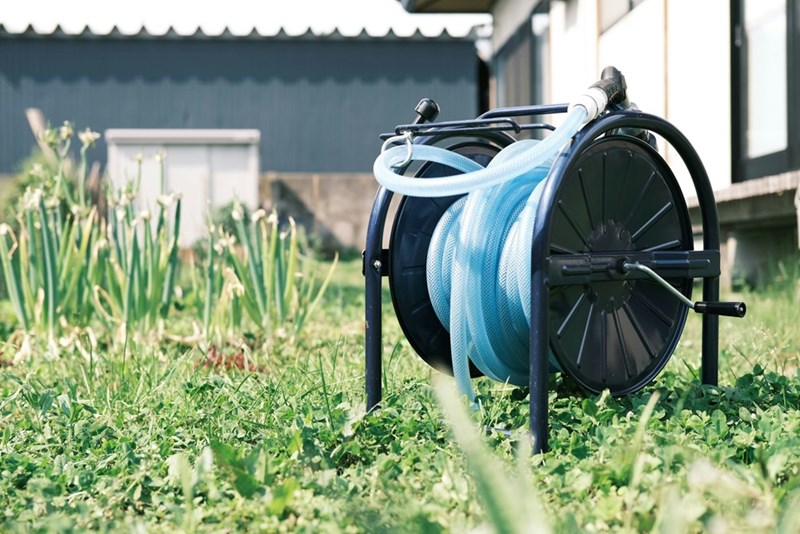 A hose reel in a backyard.