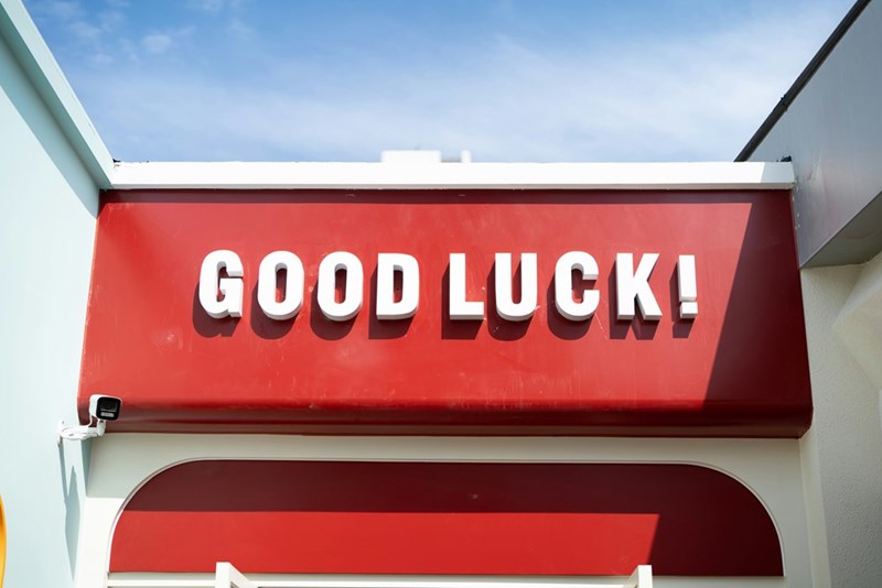 a red and white sign that says good luck