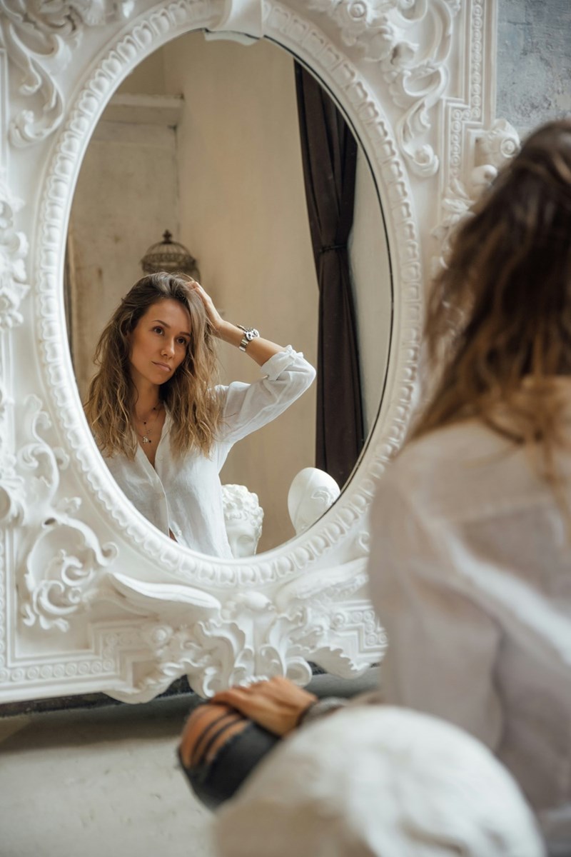 woman looking at her reflection