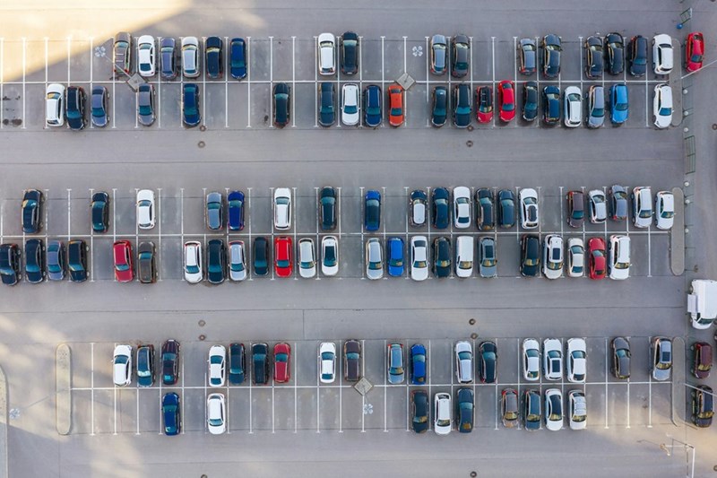 Apartment parking lot with assigned spaces and limited availability for residents and guests.