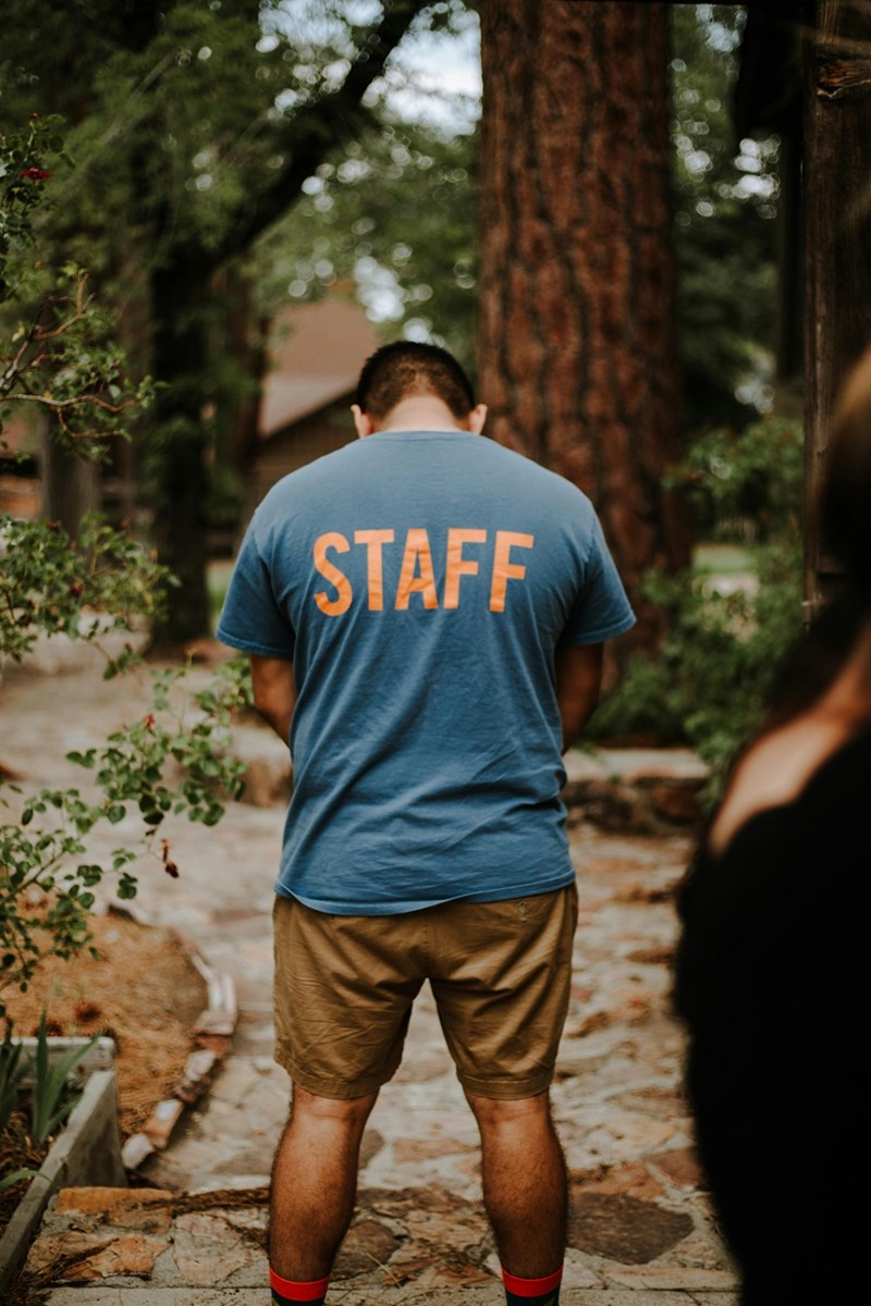 Camp counselor wearing a ‘Staff' T-shirt.
