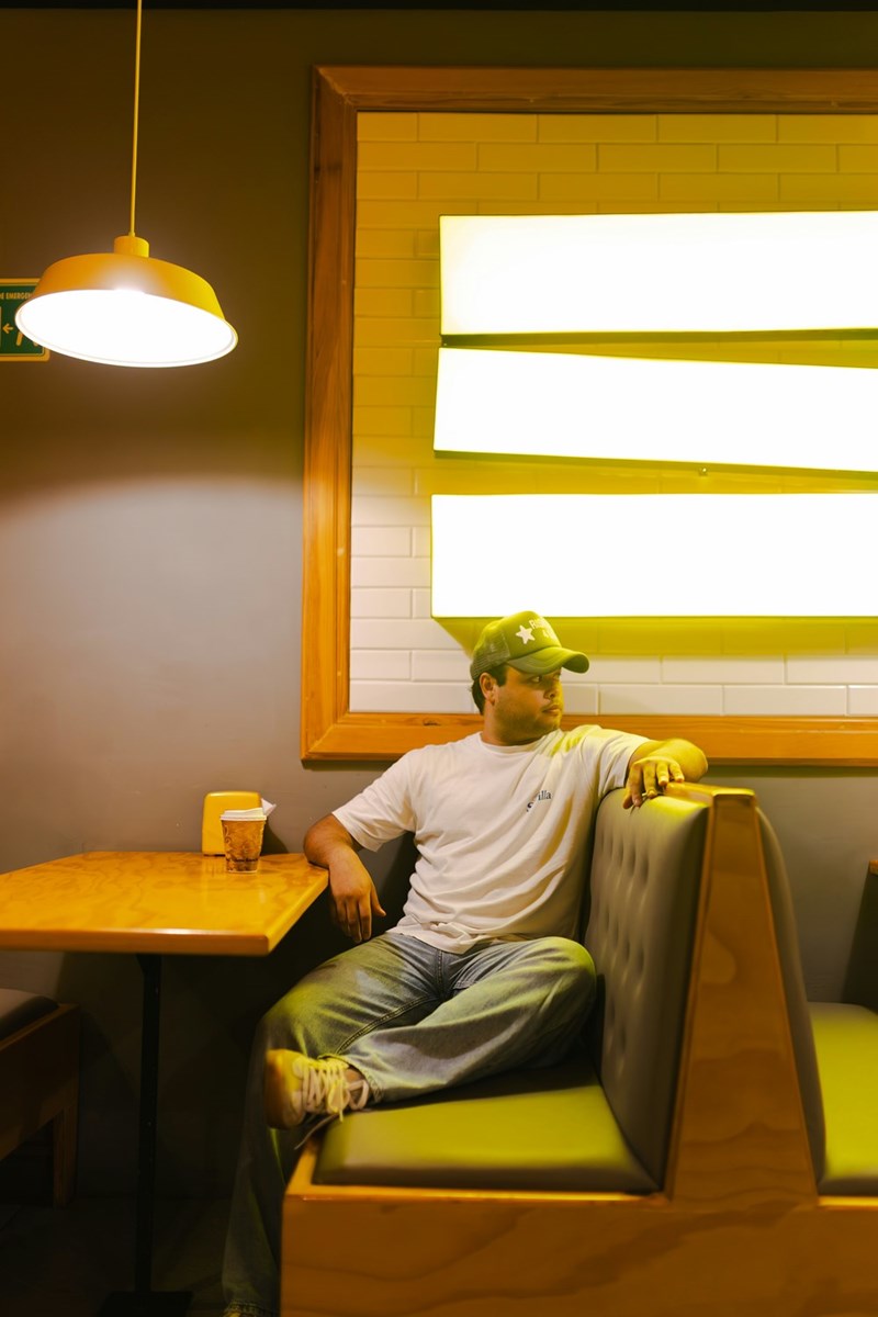 man sits in booth at diner