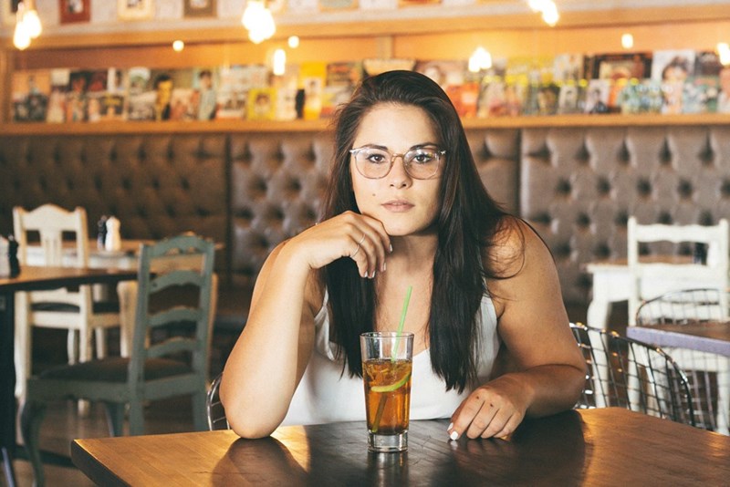 woman in a restaurant with a serious face
