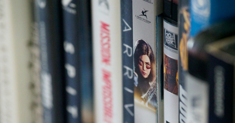 A close-up of a shelf of DVDs