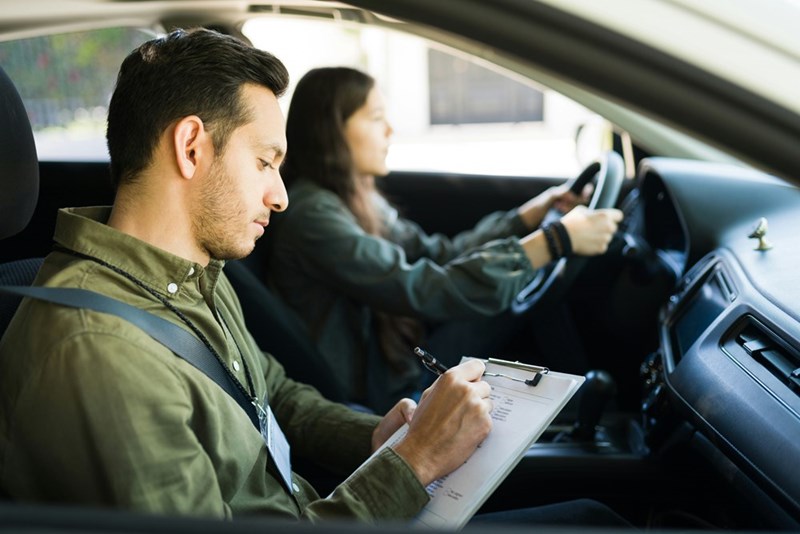 Teen driver taking a driving test while waiting for the car his mother had promised him.