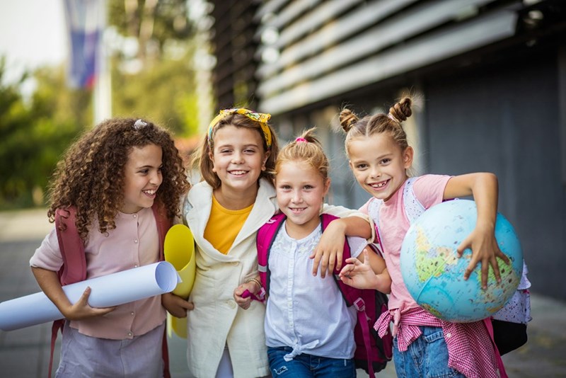 Students at the school where the teaching assistant works, who are learning by example that they don't need makeup to be valuable or beautiful. 