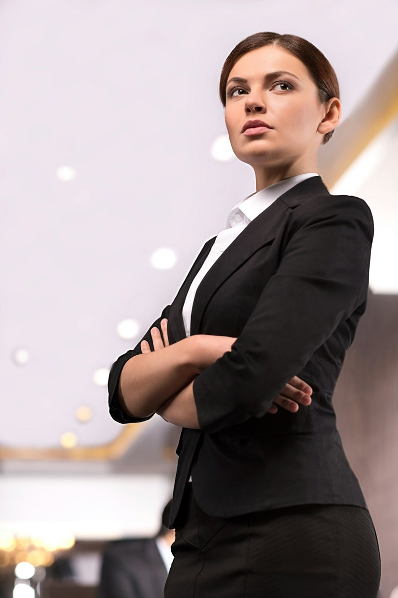 A young professional woman who is wearing makeup to her job, which may or may not be a sign of professionalism to her and the people with whom she works.