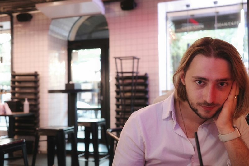 a man leans on his hand in a restaurant