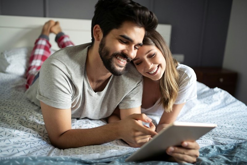 Young couple spending time alone in a bedroom while staying with the boyfriend’s family every other week.