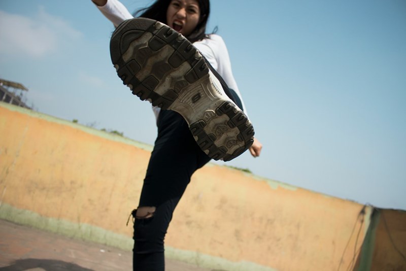 woman kicking the camera