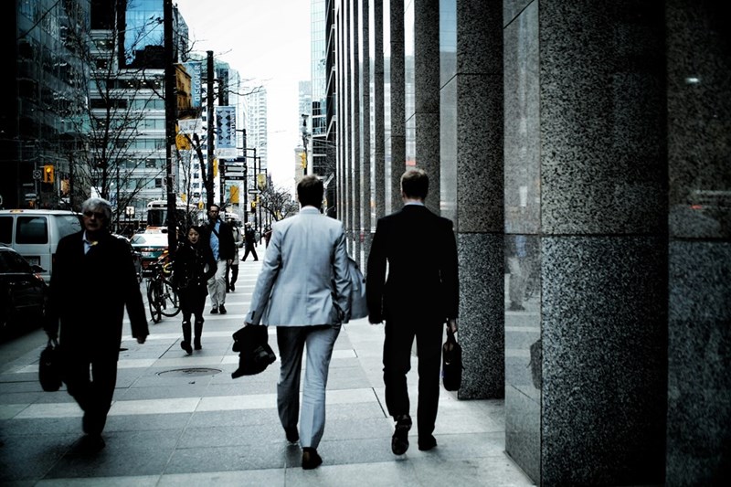 man in a suit walking out of a building