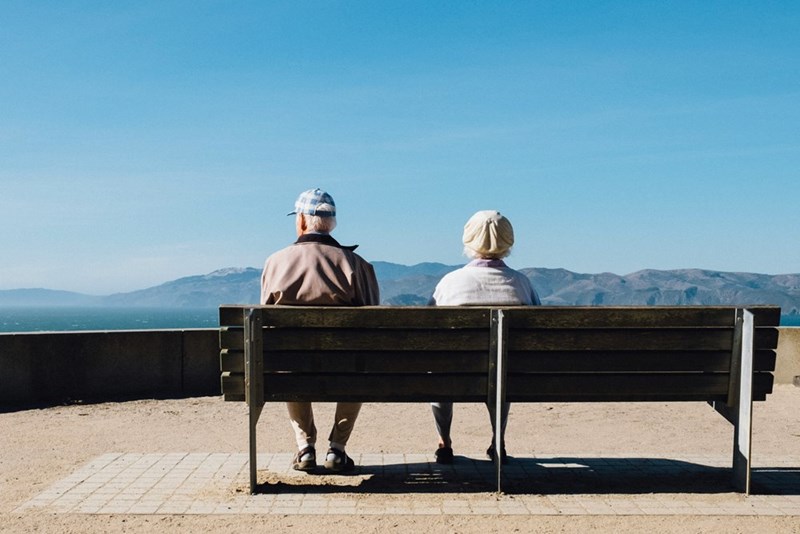 eldery couple sitting on bench