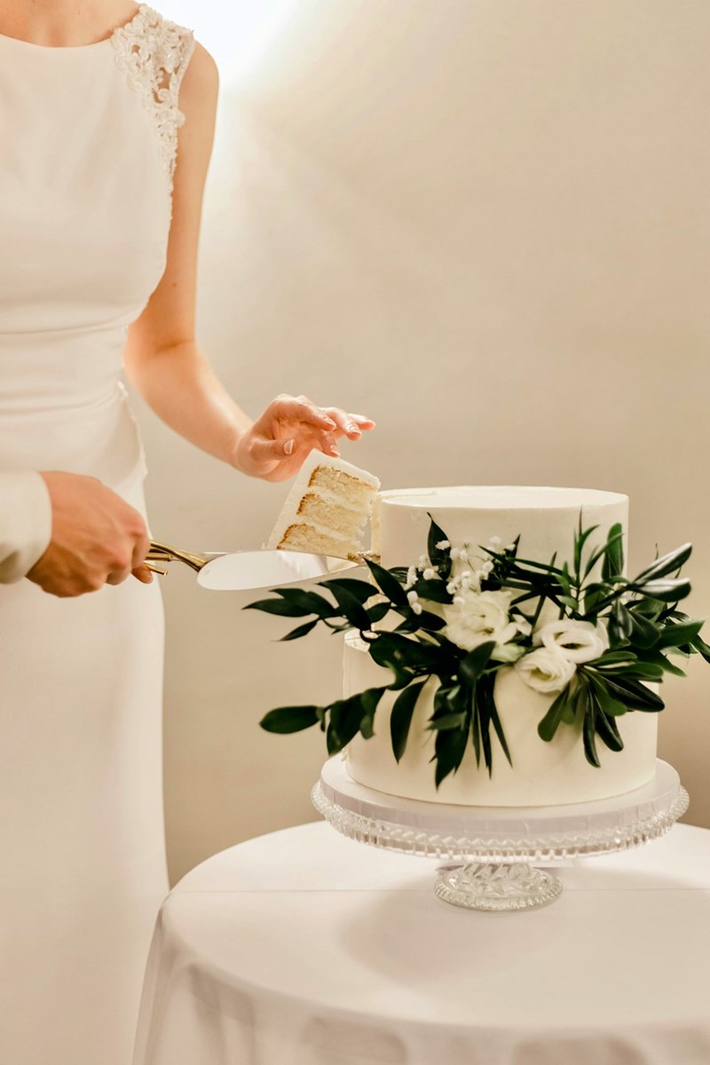a couple cutting a wedding cake