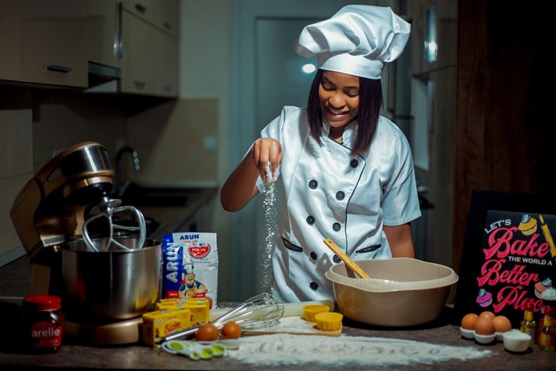 woman baking with ceffs hat
