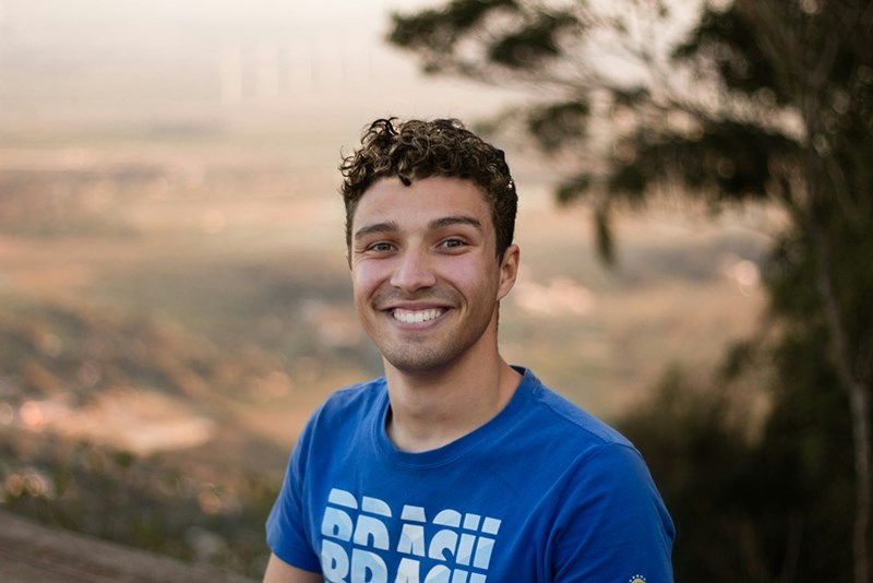 A young adult man smiling at the camera.