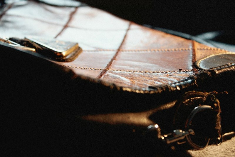 A destroyed expensive purse in low light