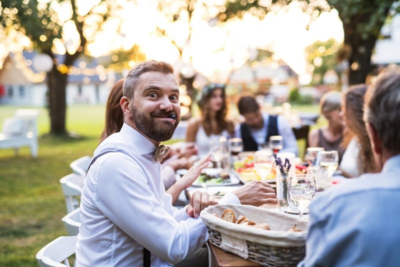 A wedding guests eats at a table at the reception