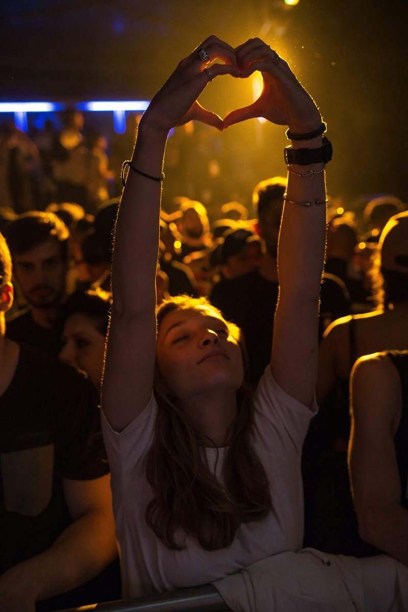 woman at crowd raising her hands