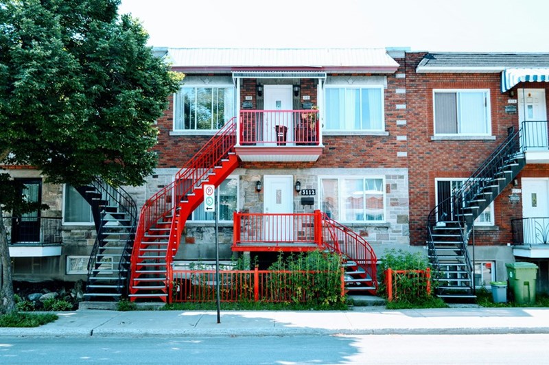 Exterior view of a multi-unit duplex similar to the Wisconsin rental property where a utility account mix-up left a longtime tenant without electricity.