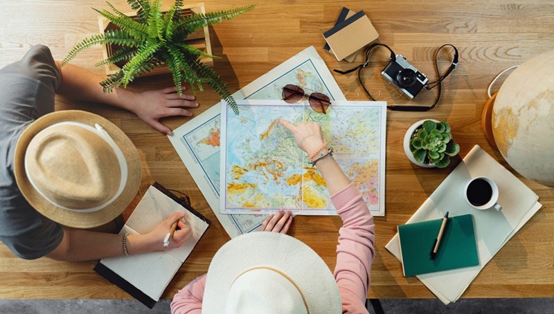 Family members plan a trip around a map.