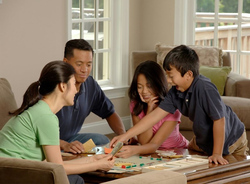 A family gathering around the dinner table, talking. Representation.