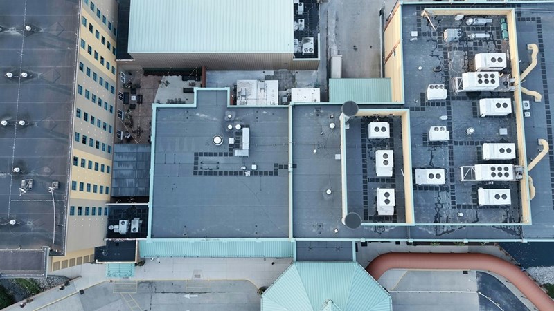 Elevated view of apartment rooftops and urban buildings in a densely populated city.