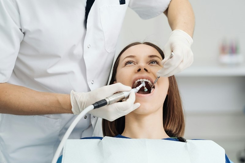 Overview of dental caries prevention girl at the dentist chair during a dental scaling procedure healthy smile