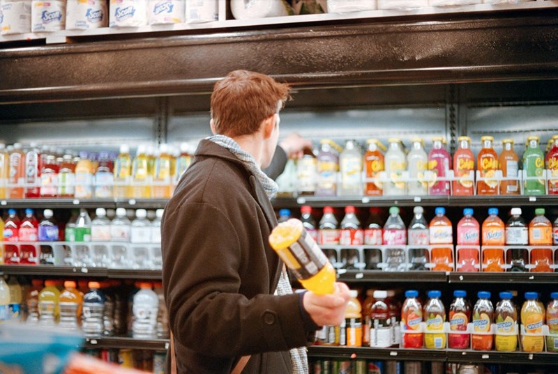 Man shopping for drinks in a supermarket