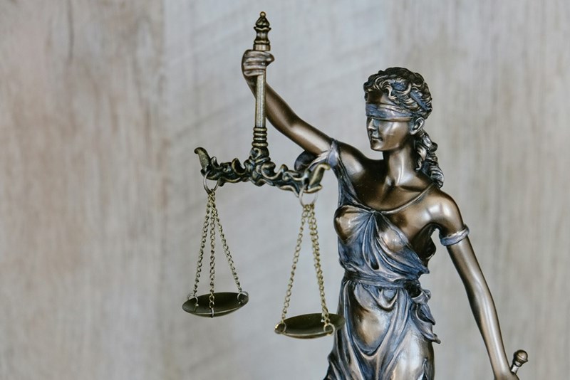 The symbol of justice, the blindfolded woman with the balance in her hand.