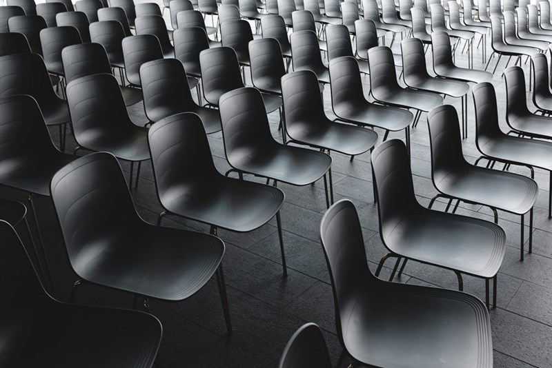 Black chair seats displayed in a room.