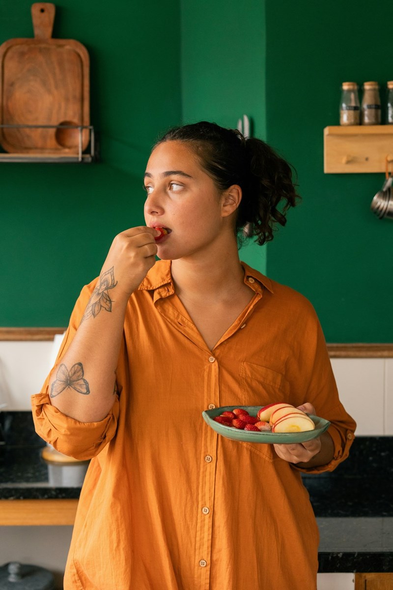 A woman with a plate of food in her hand