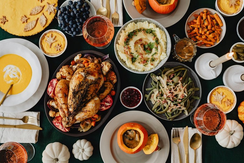 A Thanksgiving dining table filled with food during a shared family meal.