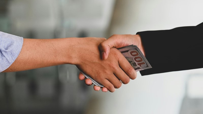 Close-up of cash changing hands, representing the financial pressure and risky loan request at the center of the family dispute.