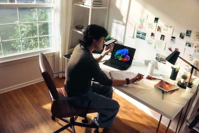 A man working at his desk with his computer and notebooks. Representation.