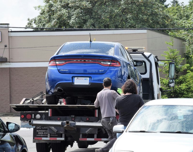 A tow truck removes a car after it was parked on private property despite multiple warnings from the homeowner.