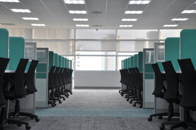 The engineer returns to an office filled with identical workstations that promise collaboration but fail to match the productivity of a well-equipped home setup.