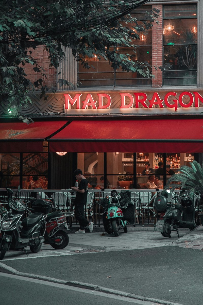 Outdoor restaurant with patio seating in a mixed-use neighborhood.